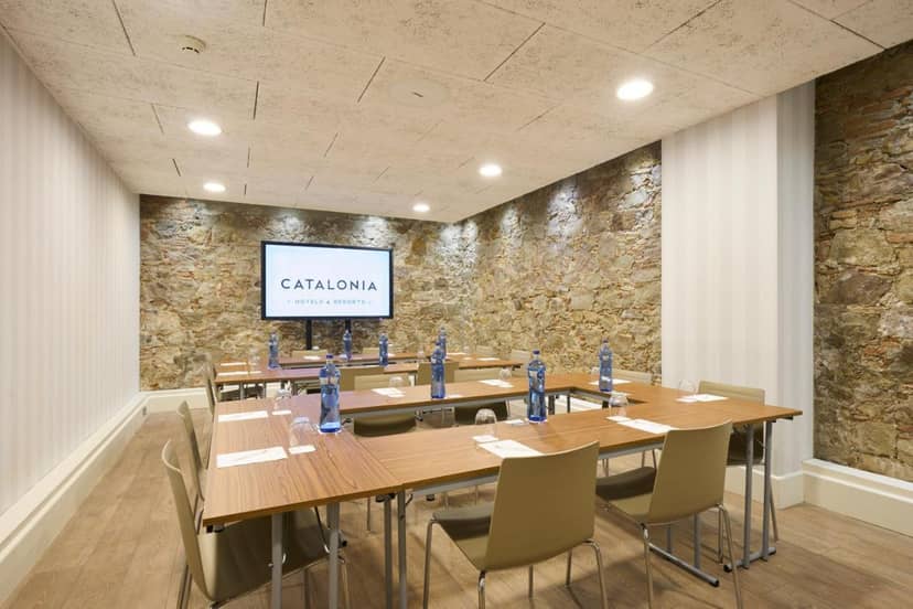 U-shape boardroom in Catalonia with stone walls for executive meetings and strategy sessions.