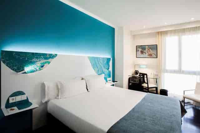 Olivera Lounge guest room with modern workspace, perfect for corporate retreats and business travel.