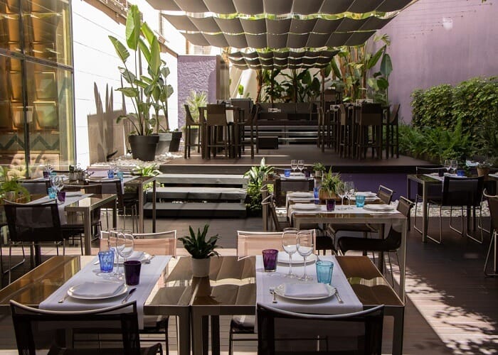 Terrassa 4 Capellans rooftop corporate reception venue with lush greenery and tiered seating.