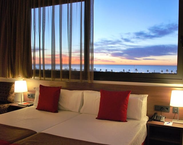 VIP hotel room in Barcelona with sunset view, luxury accommodation for corporate events.