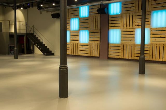 Industrial-chic event venue with pallet wall, perfect for brand activations and corporate launches.