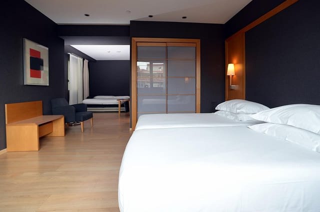 Contemporary Universal Room hotel suite for VIP business meetings and remote work.