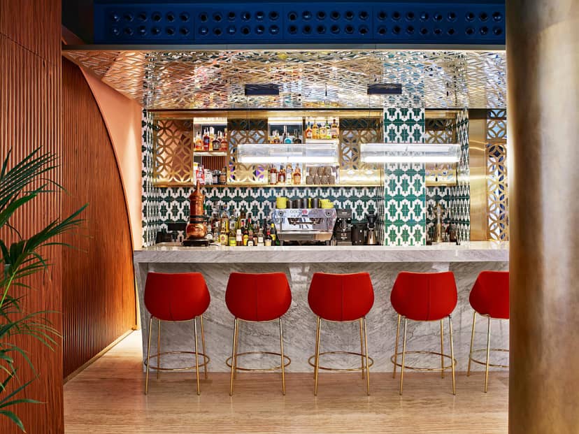 Upscale Fauna bar with red stools for chic networking events and receptions.