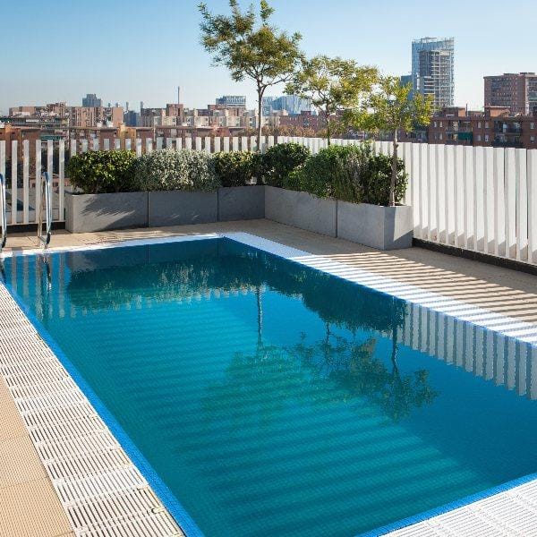 Paner rooftop pool bar at Vincci Bit, chic minimalist space for VIP evening networking cocktails.
