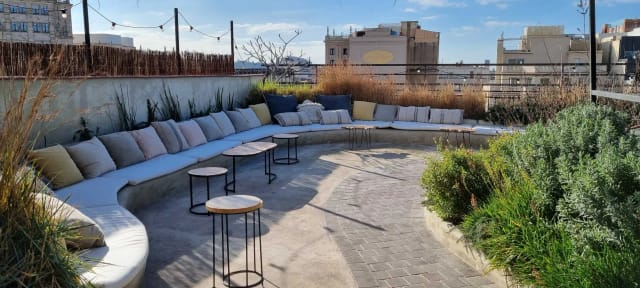 Rooftop terrace lounge setup for high-end networking reception and cocktail hour event.