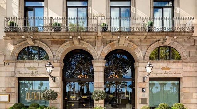 Luxury hotel facade at Duquesa de Cardona for upscale corporate retreats and executive meetings.