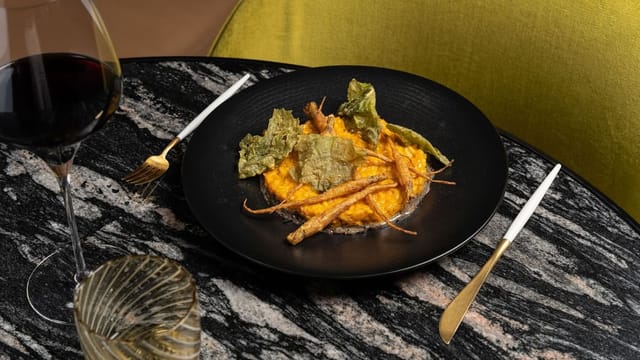 Vegetarian entrée on black stoneware for executive dinner at Almanac Barcelona.