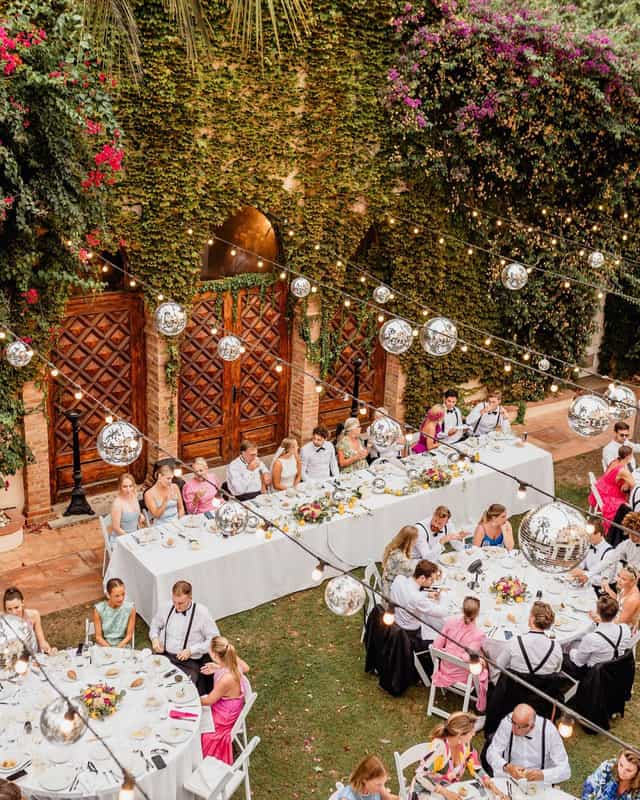 Al fresco wedding reception with festoon lighting and disco balls at Gran Villa Rosa.