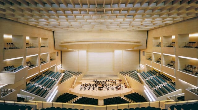 Auditori L'illa foyer: sophisticated tiered seating for corporate keynote and gala events.