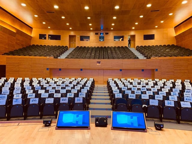 Auditori L'illa foyer with socially distanced seating for corporate events and conferences.