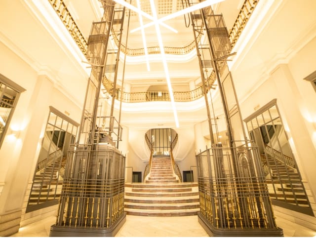 Grand historic staircase and atrium at Hub Gran Vía for luxury brand activations and gala events.