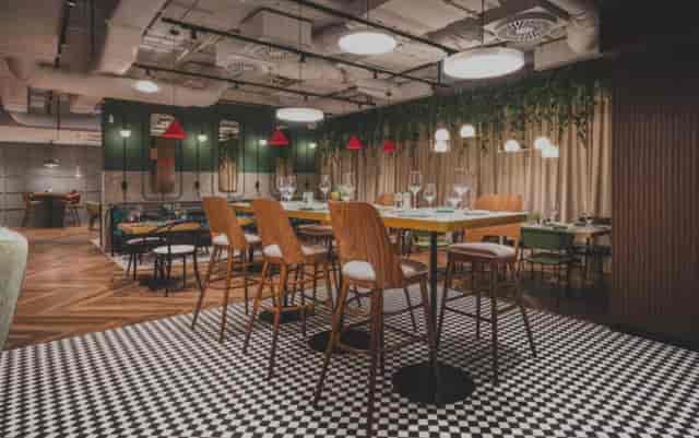 Modern industrial break-out room at Royal Tulip Warsaw Centre for networking and workshops.