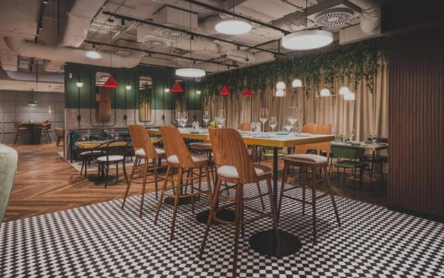 Modern industrial break-out room at Royal Tulip Warsaw Centre for networking and workshops.