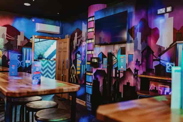 Karaoke room at Roxy Lanes Edinburgh, vibrant mural backdrop for team building and networking.