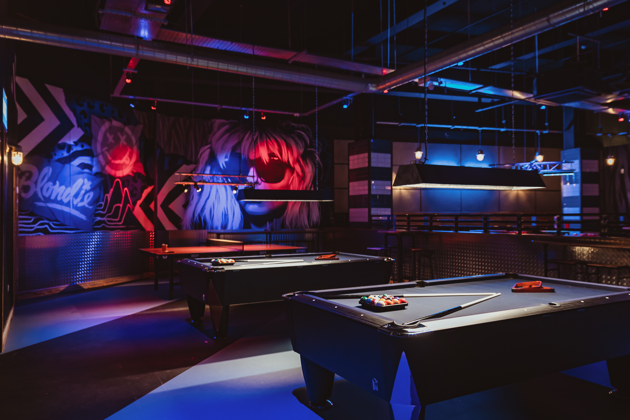 Vibrant event space with pool tables and murals at Roxy Lanes, Cardiff, for corporate events.