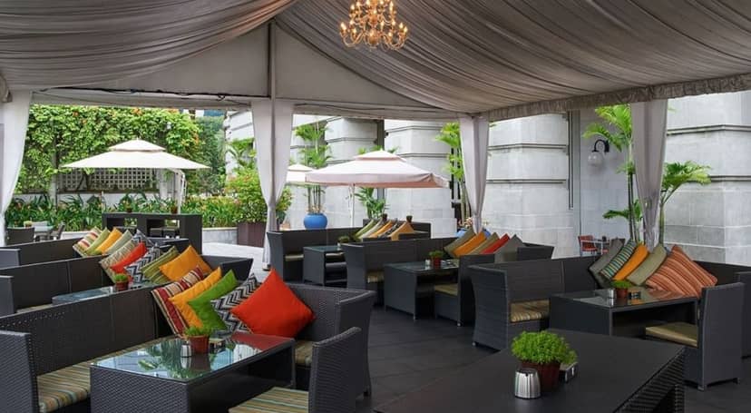 Elegant outdoor event space at The Fullerton Hotel Singapore with lush greenery.
