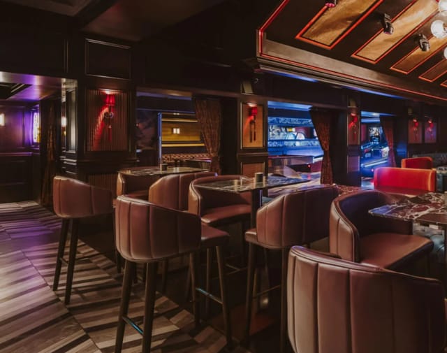 Moody lounge with plush seating for corporate mixers and VIP networking events.