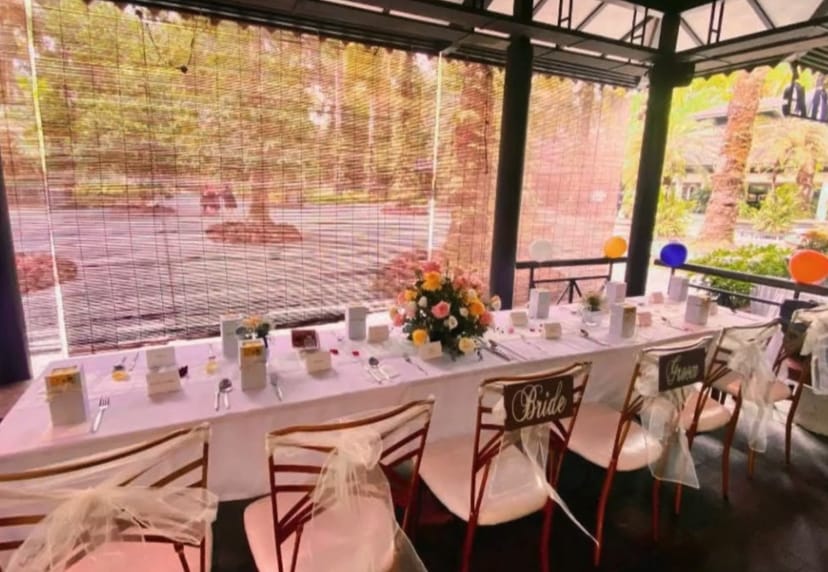 Wedding head table with floral decor at Prive ACM open-air wedding venue.
