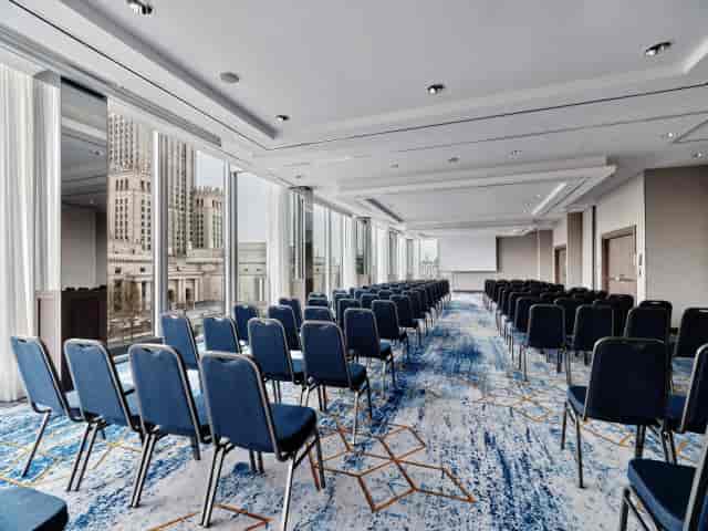 Modern conference room in InterContinental Warsaw with blue chairs and city view for events.