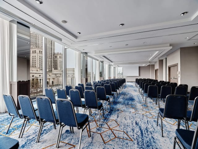 Modern conference room in InterContinental Warsaw with blue chairs and city view for events.