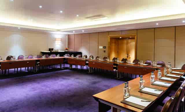 Nelson Room in Corinthia London, U-shaped layout for meetings, elegant decor, professional venue.