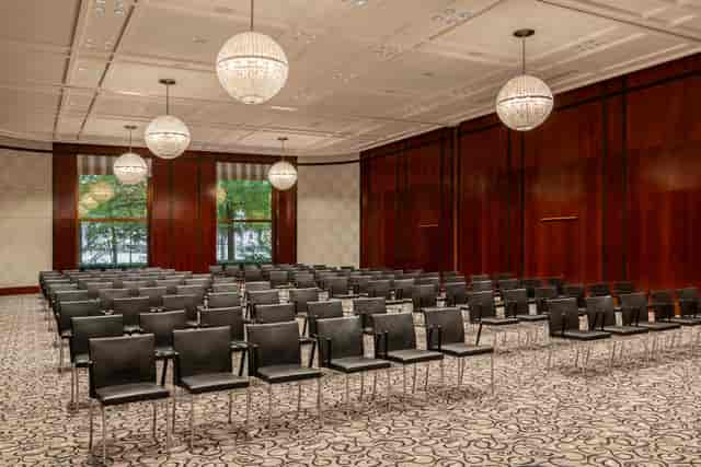 The Charles Hotel Ballroom in Munich, featuring sleek black chairs for professional conferences.