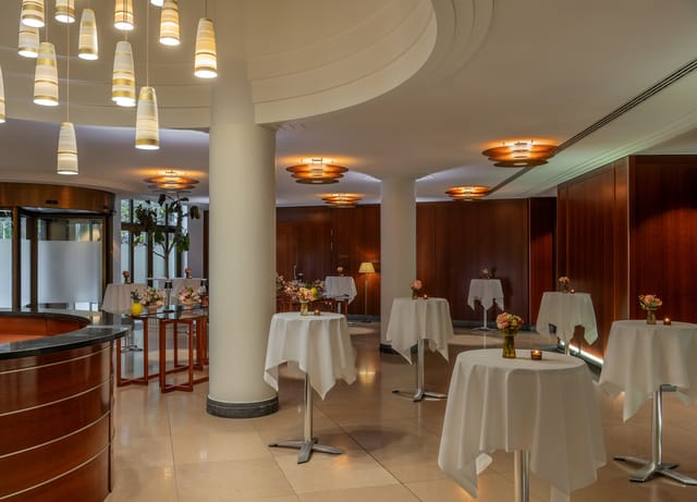 The Charles Hotel Ballroom in Munich, elegant event space with cocktail tables for gatherings.