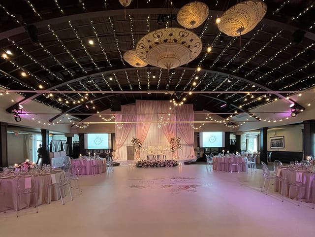 Elegant Palais Royale ballroom with draped stage, ideal for luxury weddings and galas.