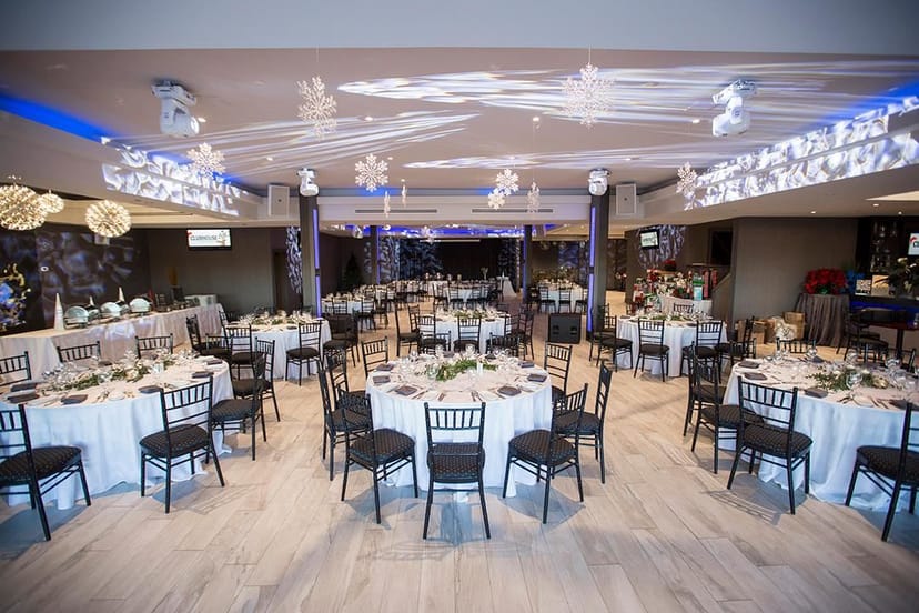 Corporate holiday party at The Vue featuring professional gobo lighting and elegant table settings.
