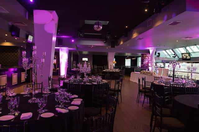 Purple LED gala banquet at The Vue event venue with crystal centerpieces.