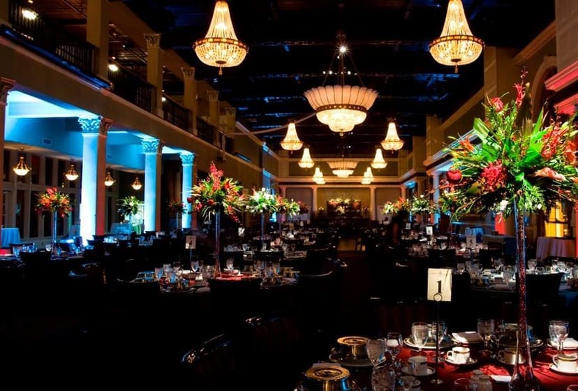 Gala setup with crystal chandeliers at Liberty Grand Courtyard for elegant awards dinner.
