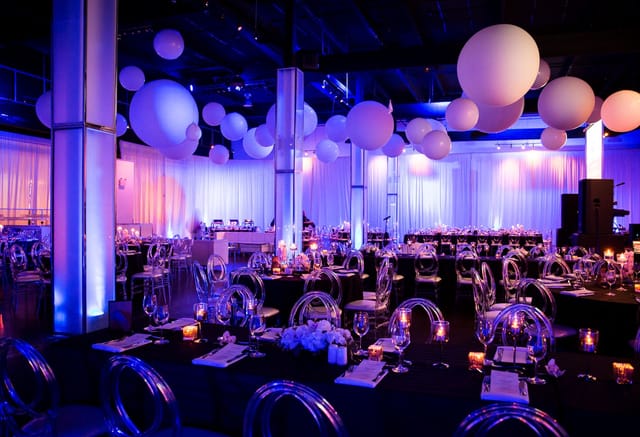 Modern banquet hall at The Warehouse with purple lighting, ideal for gala or corporate event venue.