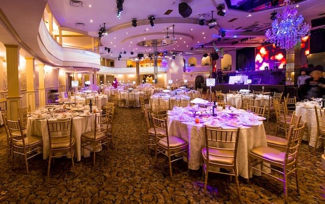 Ballroom banquet hall with gold Chiavari chairs for corporate events and luxury social galas.
