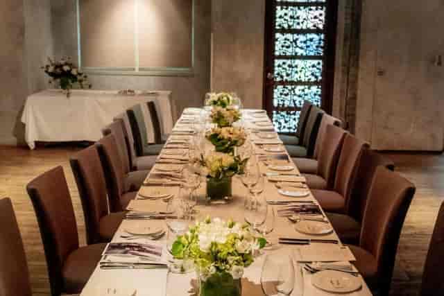 Private dining at GEORGE Restaurant featuring floral centerpieces for formal boutique events.