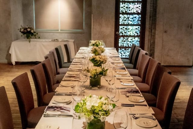 Private dining at GEORGE Restaurant featuring floral centerpieces for formal boutique events.