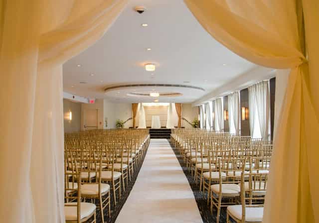 The Eglinton Grand theater-style ceremony with white aisle runner for corporate events or weddings.