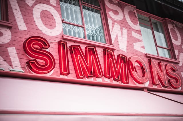 Vibrant "SIMMONS" signage at trendy venue for networking and social events.