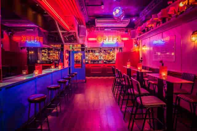 Neon-lit Simmons Bar interior for evening networking and corporate receptions.