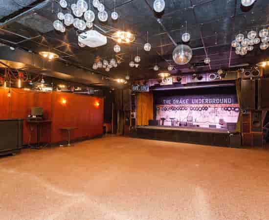 Drake Underground industrial venue with stage for intimate live events and product launches.