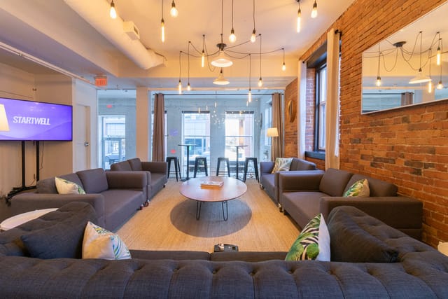 Loft-style meeting room with lounge seating for corporate brainstorming and networking events.