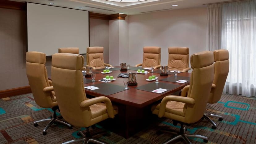 Boardroom setup with leather seating for executive meetings and corporate events.