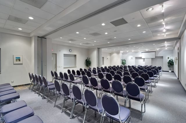 Theater-style conference room with modular partitions for corporate events and presentations.