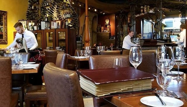 Upscale Via Allegro dining room with formal table settings for client dinners and networking events.