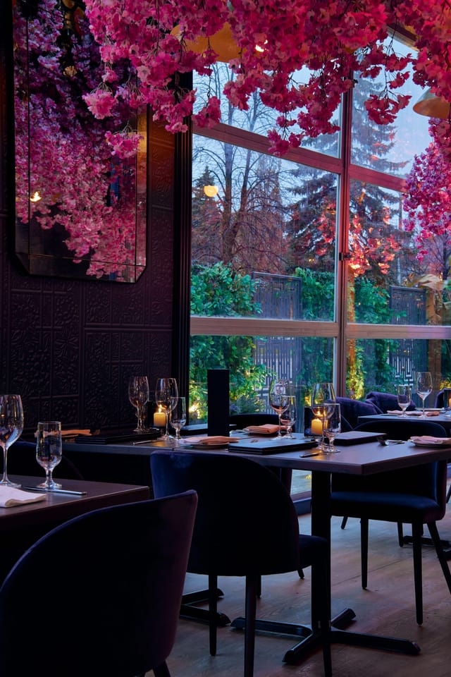 Upscale Via Allegro patio for executive dinners and networking with lush greenery.