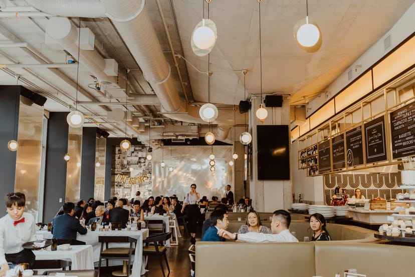 Industrial-chic Ricarda's restaurant with booth seating for corporate events and dinners.