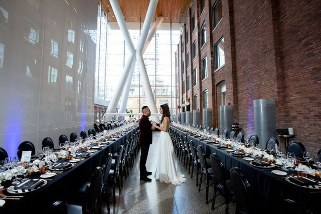 Ricarda's industrial event venue with long table seating for weddings and corporate gatherings.