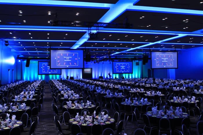 Ballroom gala dinner at Toronto Congress Centre with LED lighting and AV screens.