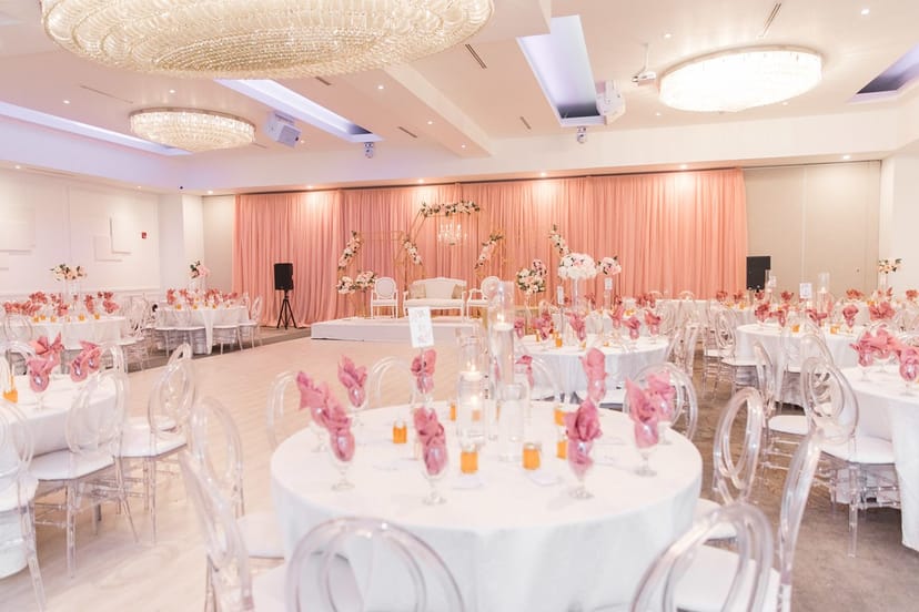 Elegant wedding reception with ghost chairs at Toronto Grand Banquet & Convention Centre.