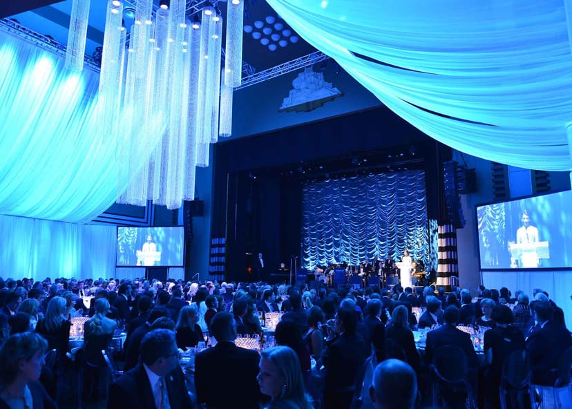 The Carlu gala ballroom featuring ceiling draping and stage screens for awards dinner events.
