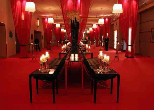 Clipper Room at The Carlu featuring red lounge decor for a sophisticated VIP cocktail reception.